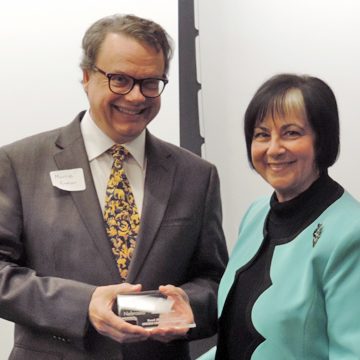 Lincoln Community Playhouse director Morrie Enders accepts the RAN Champion award from Sally Ganem